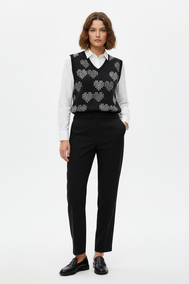 Geometric hearts vest layered over white shirt for smart-casual look