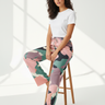 Woman sitting in camo-print pajama pants