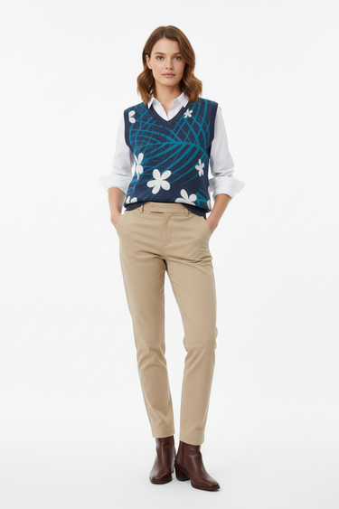 Tropical palm vest layered over white shirt with chinos