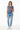 Geometric tribal vest styled casually with light wash denim and white sneakers