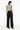 Back view of vest styled with wide-leg trousers