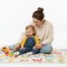 Parent teaching child with ABC blanket white background