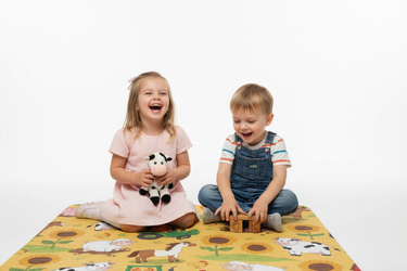 Siblings playing on Sunny Farm blanket white background