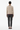 Back view of abstract art sweater with dark trousers