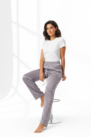 Woman sitting in satin pajama pants