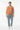 Alppeer orange vest styled casually with light wash denim and white sneakers