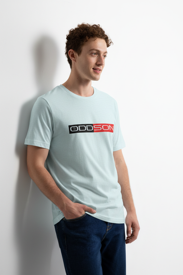Light blue t-shirt leaning against wall