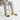 Man wearing yellow and black slip-ons with grey joggers on bench