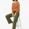 Sweater with Olive Linen Trousers Seated