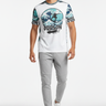 Wave rider tee with light grey tech joggers and minimalist sneakers