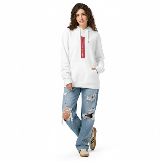 Woman in hoodie with distressed jeans and sneakers